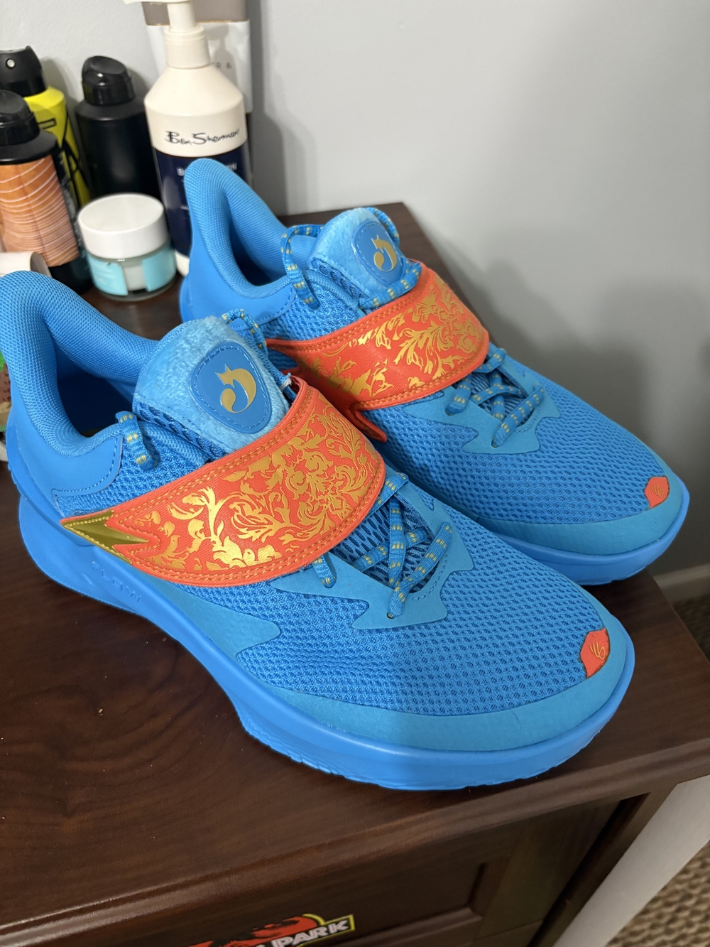 Under Armour Bright Blue Kids Sneakers with Orange Strap and Gold Accent